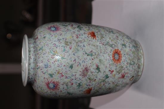 A Chinese famille rose ovoid vase, Qing dynasty, finely painted with flowers and scrolling foliage, H. 15cm, drilled hole to side of ba